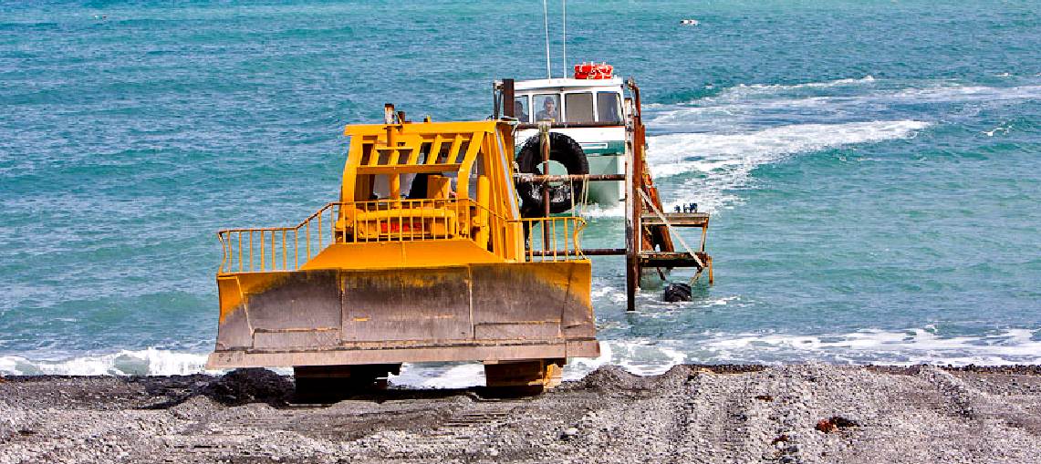 Ngawi beach in New Zealand boat recovery operations using a bulldozer