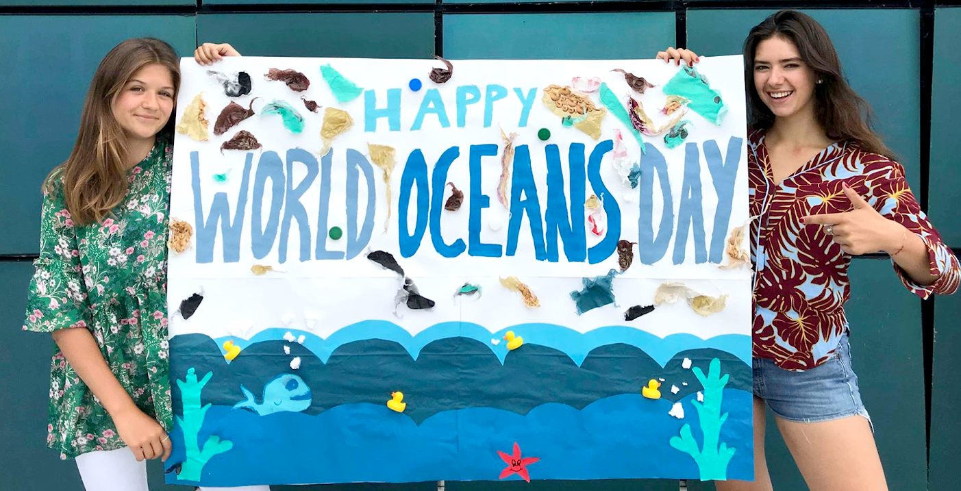Happy World Oceans Day youth girls with banner